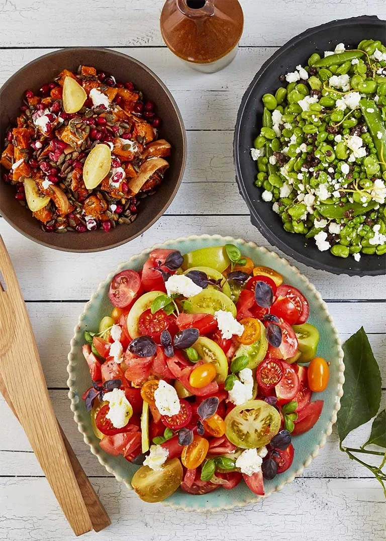 Overhead view of a variety of salads in bowls